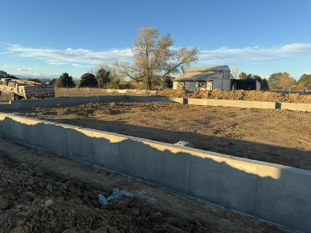 Concrete foundation installation with finished perimeter walls on residential property in Englewood